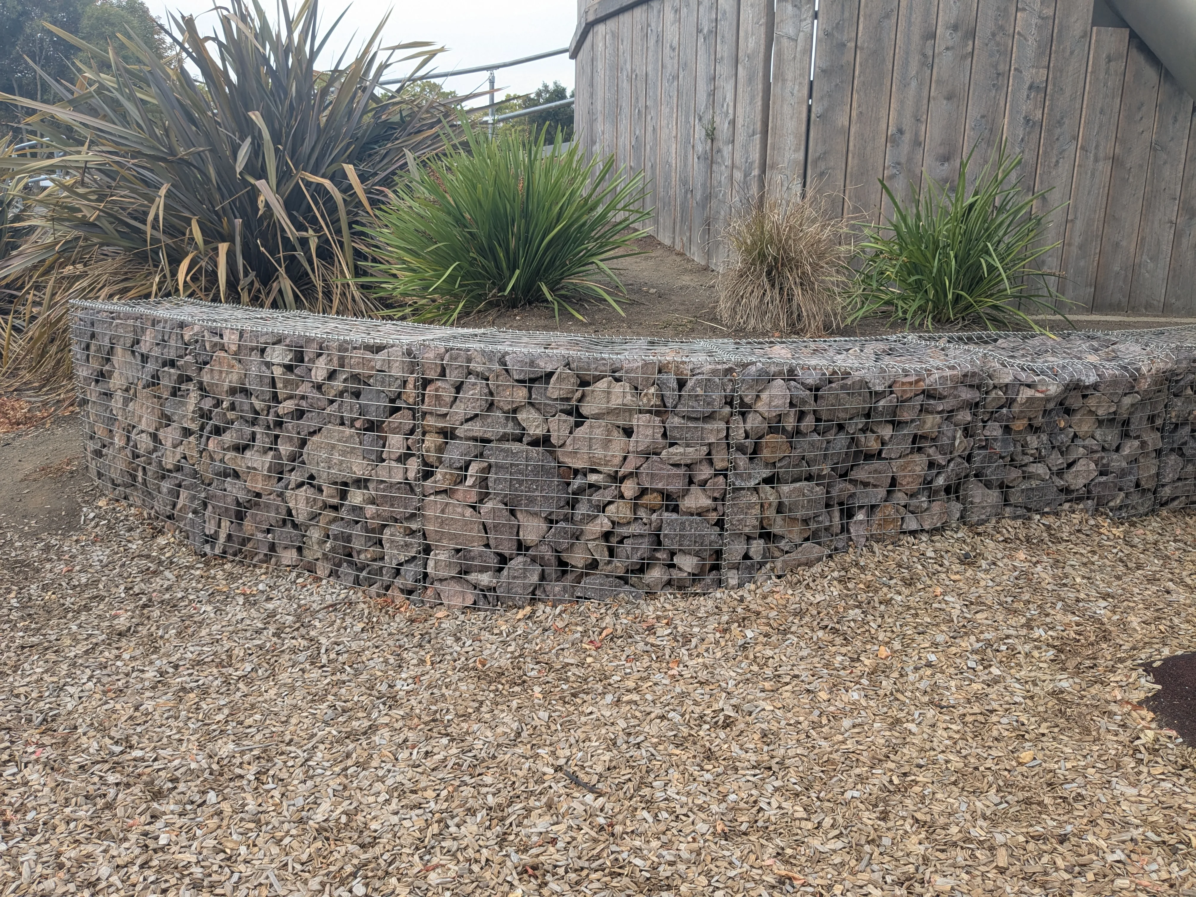 Gabion retaining wall with outdoor seating area