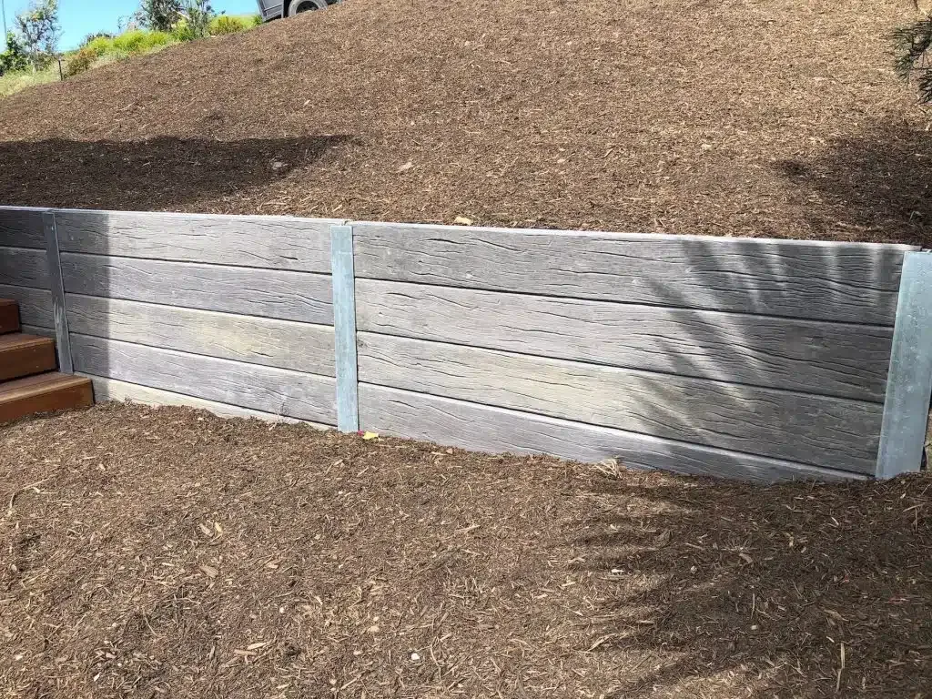 Concrete sleeper retaining wall on a sloped site