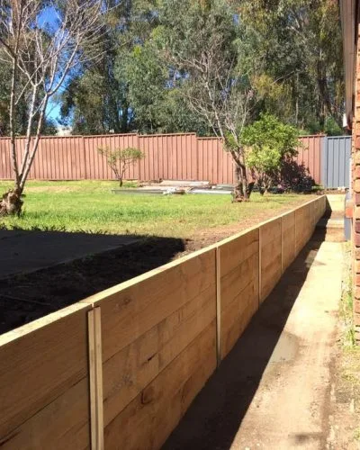 Timber retaining wall along a garden path