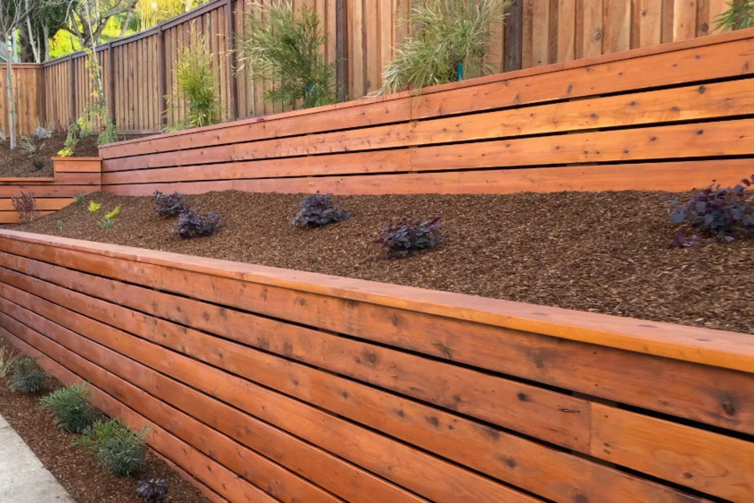 Weathered timber retaining wall with garden bed