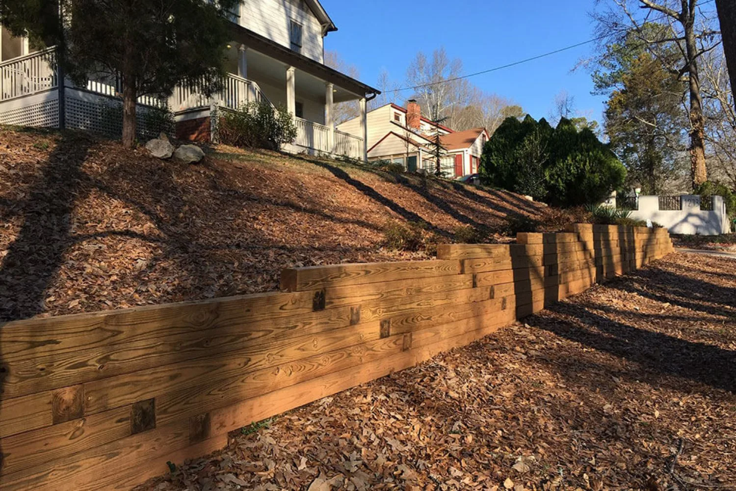 Timber retaining wall on a driveway edge